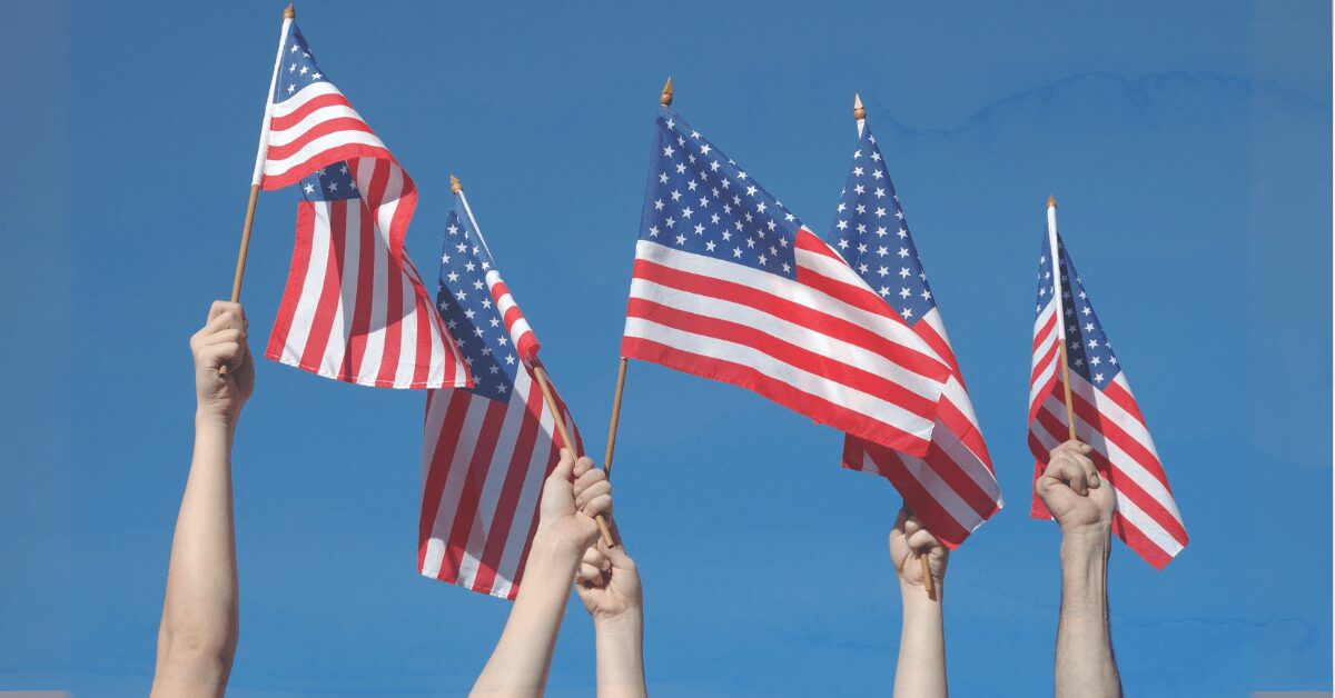 Hands waving flags for parade